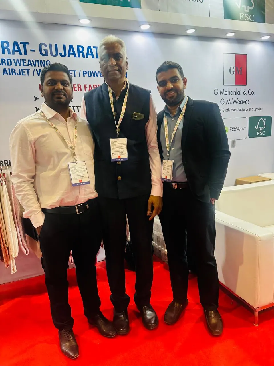 Three GM Weaves representatives photographed at the Bharat Tex 2025 booth