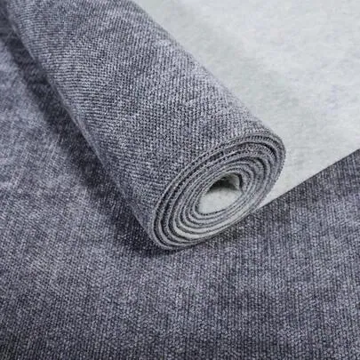 Roll of grey woven fabric showing its surface and layered edge