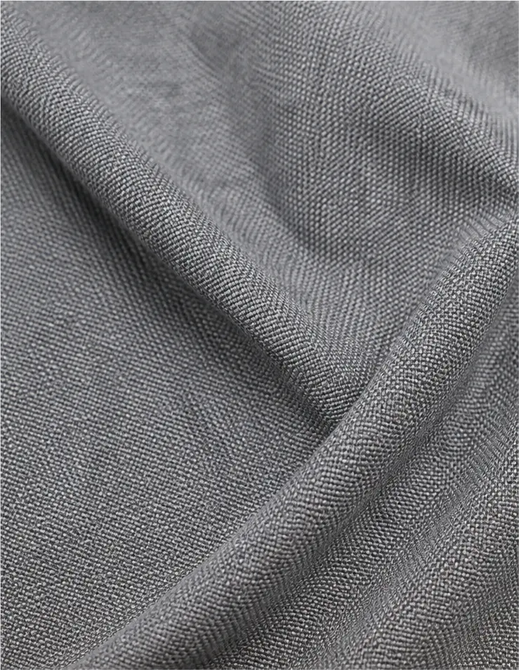 Close view of grey woven fabric showing its textured construction